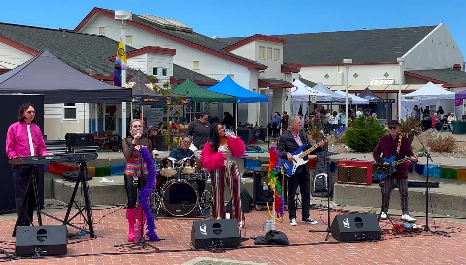 The band performing at an outdoor festival