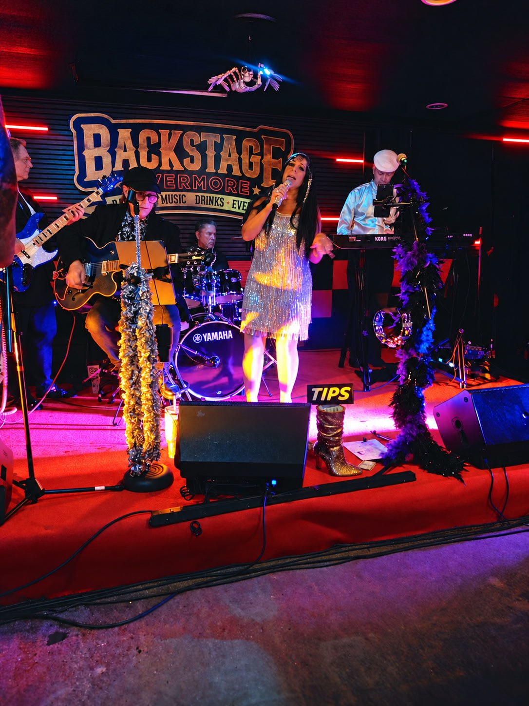 Cher Alike in a silver fringe dress performing with the full band at Backstage Livermore