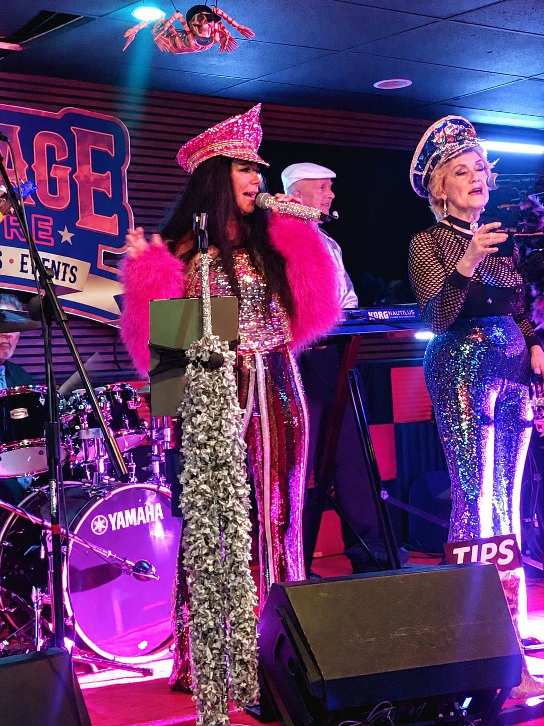 Cher Alike on stage in a pink fur jacket and rhinestone hat